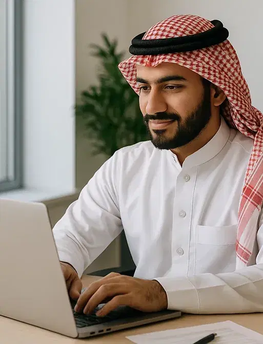 A friendly Deepora software engineer smiling while developing advanced communication technology on a laptop.